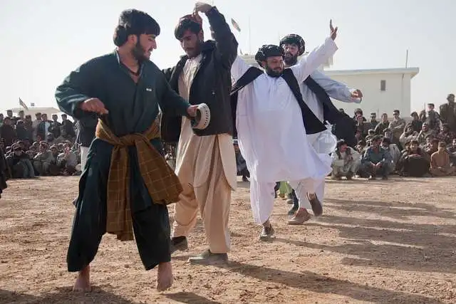 local men dance outside of the zhari district center
