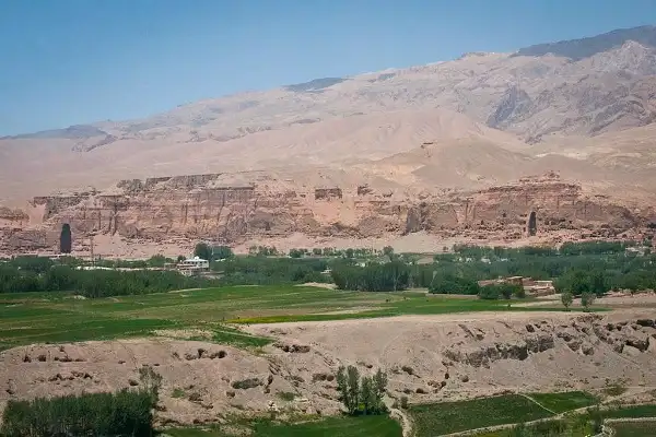 The two huge empty caverns where the famous Buddha's of Bamyan used to stand are visible against the Bamyan valley